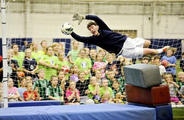 Penn State soccer goalie Danny Sheerin demonstrates how to dive to block a ball during the Mack Brady soccer clinic at Holuba Hall on Sunday. Nittany Lion soccer coaches and players led the free clinic for more than 100 youngsters. ABBY DREY — CDT photo
